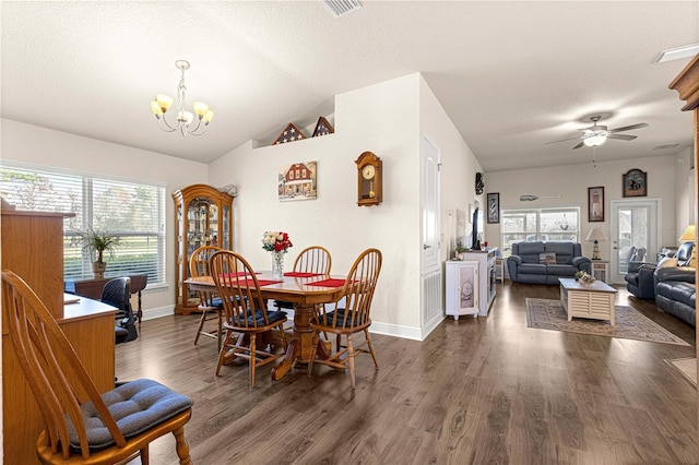 dining space with lofted ceiling, dark hardwood / wood-style floors, a textured ceiling, and plenty of natural light