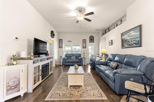 living room with ceiling fan and dark hardwood / wood-style flooring