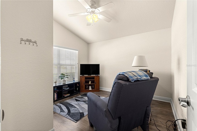 living room featuring lofted ceiling, dark hardwood / wood-style floors, and ceiling fan