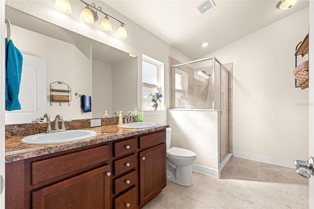 bathroom with vanity, tile patterned flooring, a shower with door, and toilet