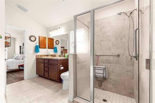 bathroom with lofted ceiling, vanity, walk in shower, toilet, and a textured ceiling