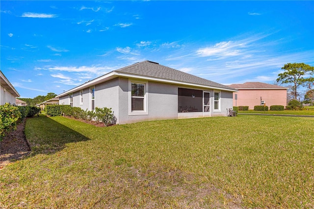 rear view of property with a lawn