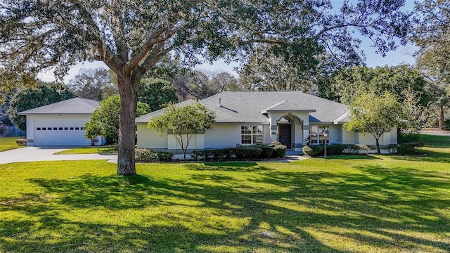 single story home featuring a front lawn, driveway, and stucco siding