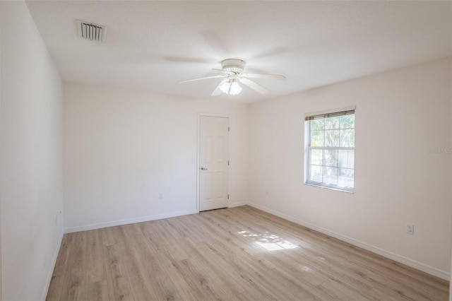 empty room featuring ceiling fan and light wood-type flooring