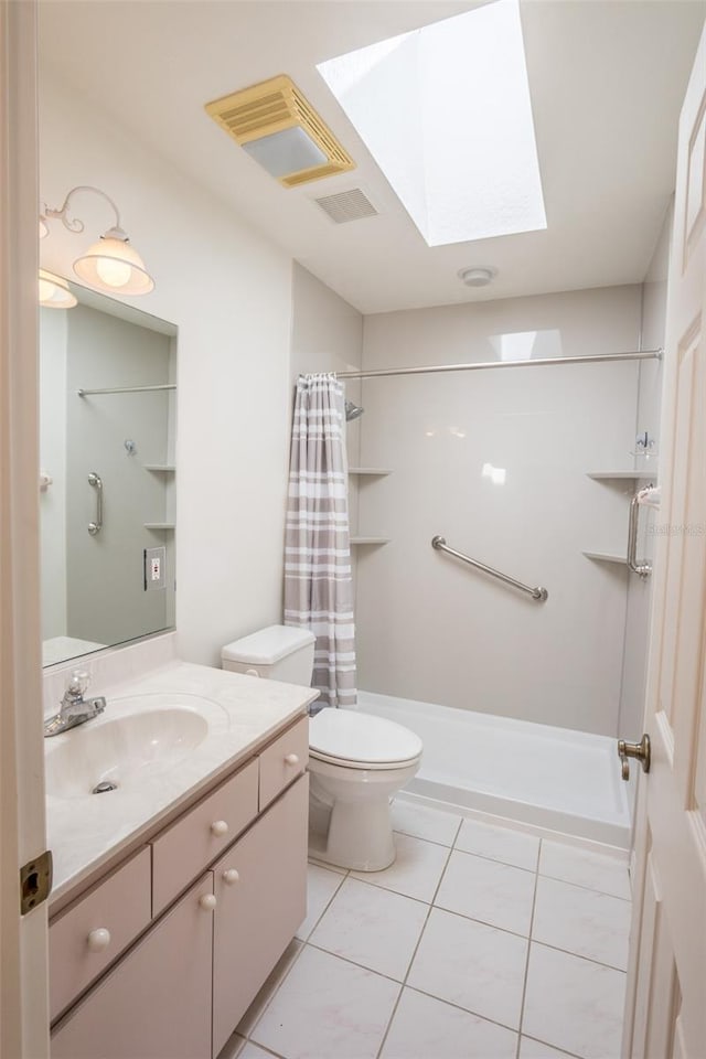 bathroom featuring tile patterned flooring, vanity, a shower with curtain, and toilet