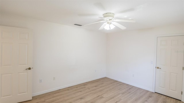 empty room featuring ceiling fan and light hardwood / wood-style flooring