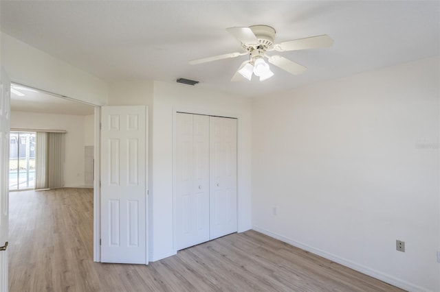 unfurnished bedroom featuring ceiling fan, a closet, and light hardwood / wood-style flooring