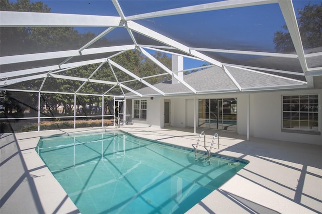 view of swimming pool featuring a patio and glass enclosure