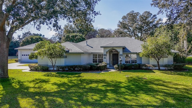 single story home featuring a garage and a front yard