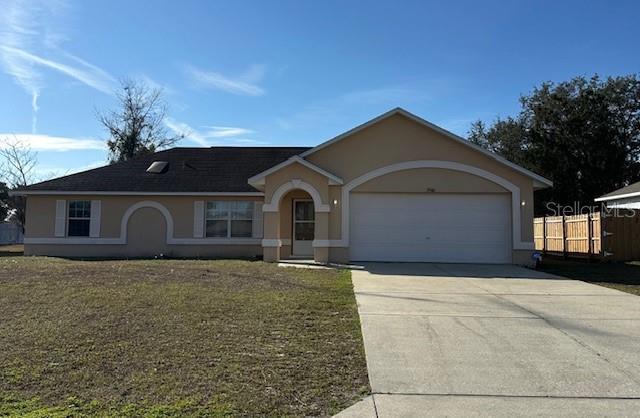 single story home with a garage and a front yard