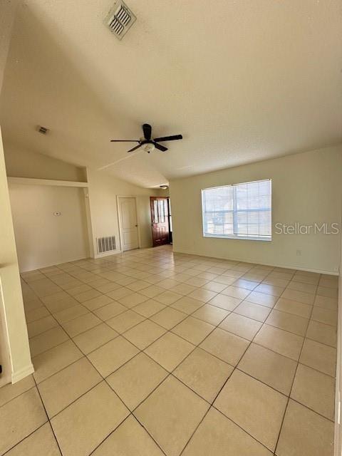 tiled empty room with ceiling fan