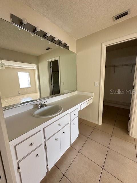 bathroom with vanity, tile patterned flooring, and a textured ceiling