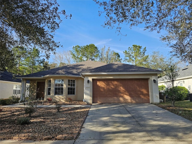 single story home featuring a garage, concrete driveway, and stucco siding