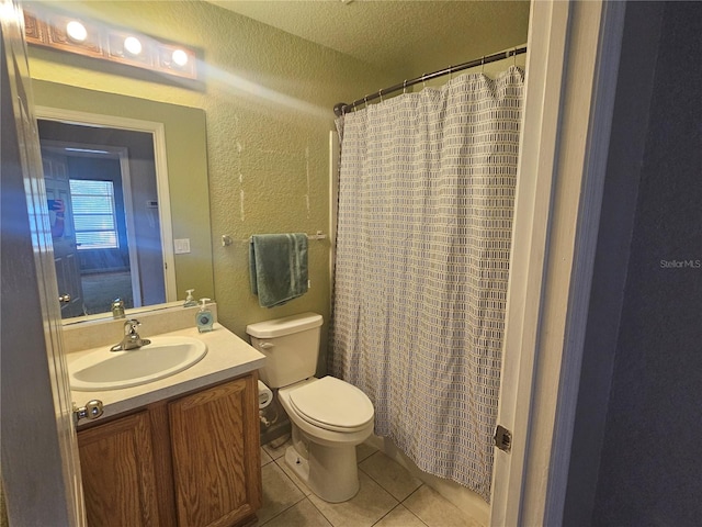 full bath with a textured ceiling, a textured wall, toilet, vanity, and tile patterned flooring