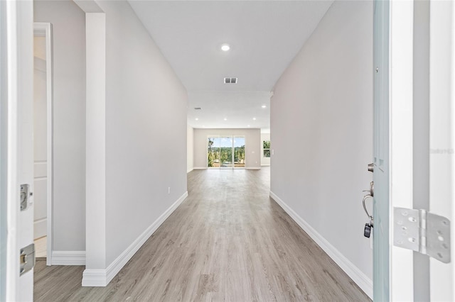 hallway with light hardwood / wood-style flooring