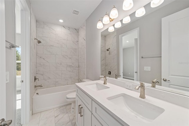 full bathroom with toilet, vanity, and tiled shower / bath combo