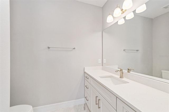 bathroom featuring vanity and toilet