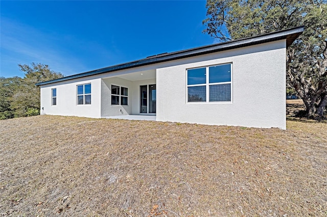 rear view of property with a yard