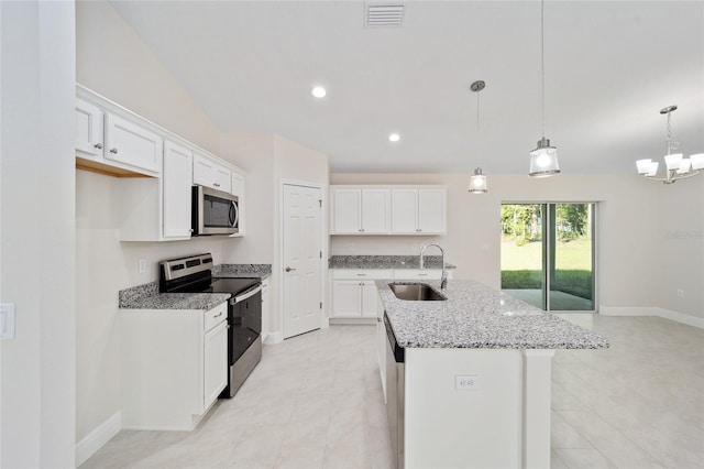 kitchen featuring appliances with stainless steel finishes, sink, an island with sink, and white cabinets