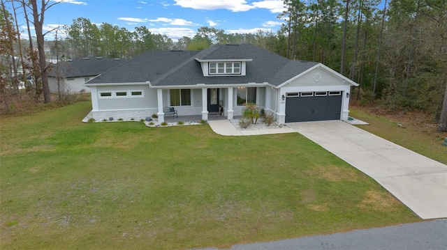 view of front of house with a porch, a garage, and a front lawn