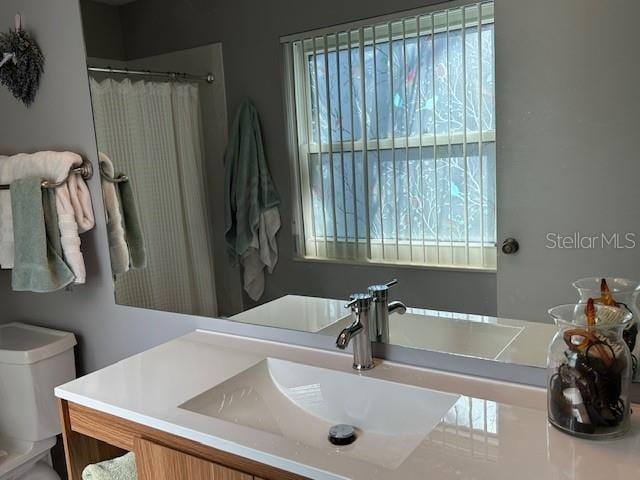 bathroom with vanity, toilet, and a shower with shower curtain