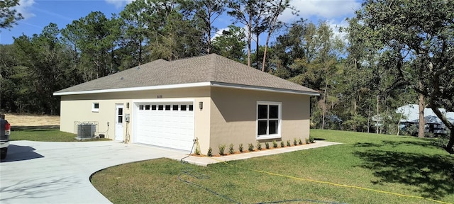 view of property exterior featuring an outbuilding, a garage, a lawn, and central air condition unit