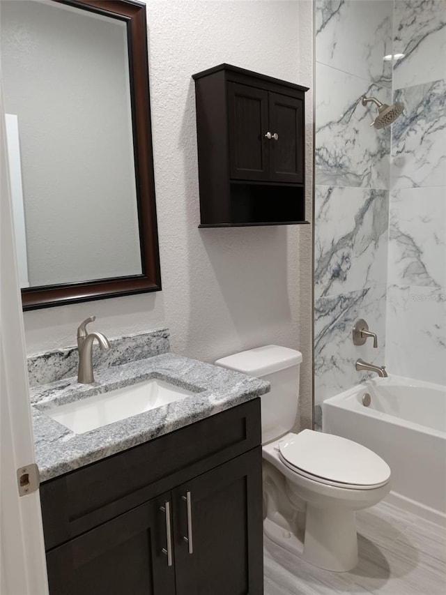 full bathroom featuring vanity, toilet, and tiled shower / bath combo