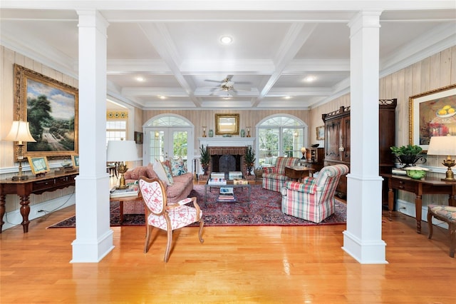 living room with a brick fireplace and decorative columns