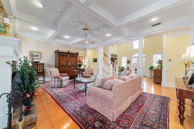 living room with coffered ceiling, light hardwood / wood-style floors, beamed ceiling, and ornate columns