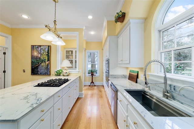 kitchen with sink, white cabinetry, decorative light fixtures, black gas stovetop, and stainless steel dishwasher