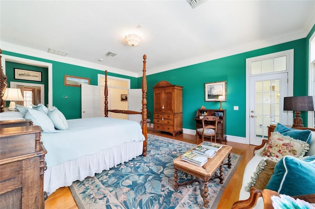 bedroom featuring crown molding and light hardwood / wood-style floors