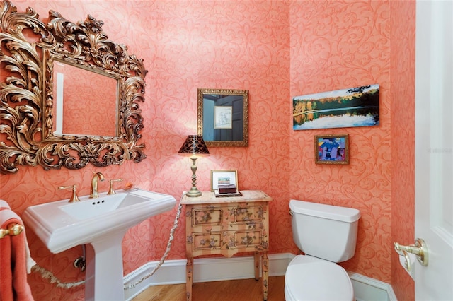 bathroom featuring hardwood / wood-style floors, sink, and toilet