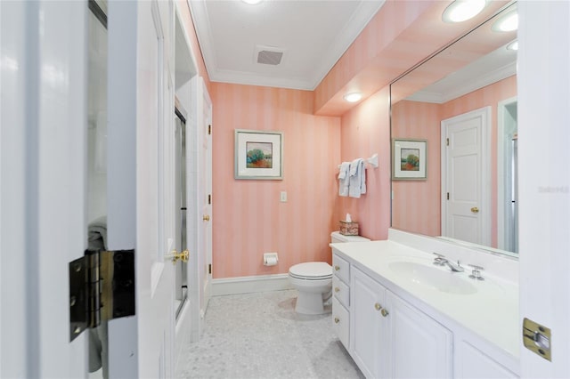 bathroom featuring vanity, a shower with shower door, crown molding, and toilet