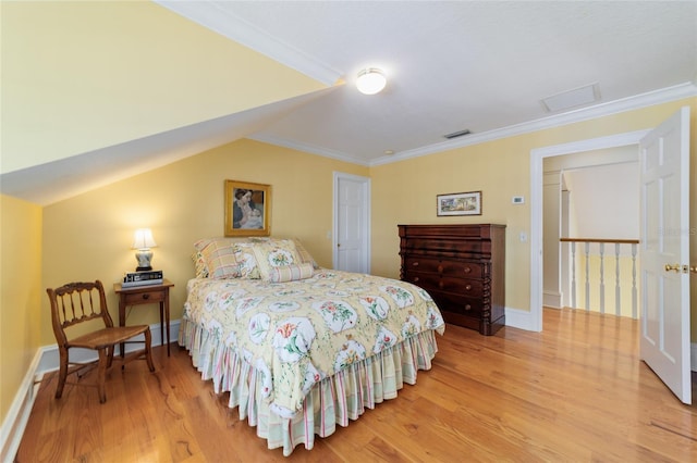 bedroom featuring wood-type flooring, lofted ceiling, and ornamental molding