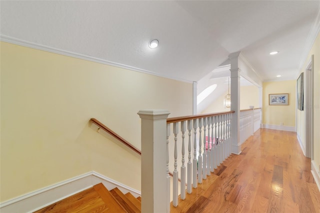 hall with hardwood / wood-style flooring and crown molding