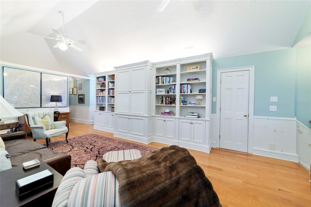 living room featuring vaulted ceiling, ceiling fan, and light hardwood / wood-style floors