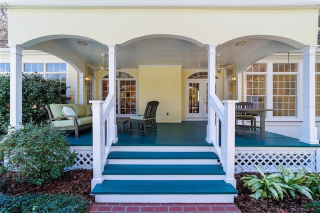 doorway to property with ceiling fan and covered porch