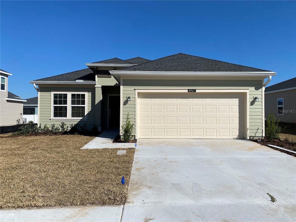 view of front of home featuring a garage and a front yard