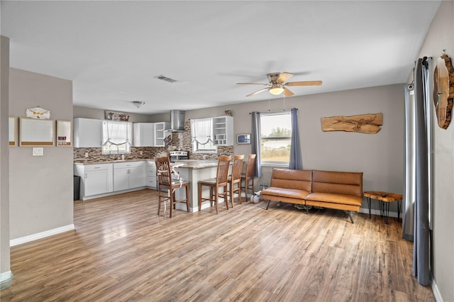 dining area featuring ceiling fan and light wood-type flooring