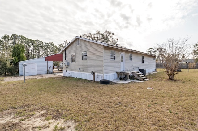 rear view of property with central AC, a garage, an outdoor structure, and a lawn