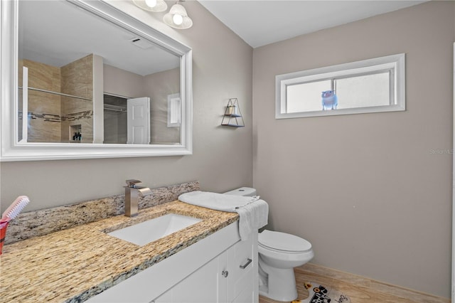 bathroom with vanity, wood-type flooring, toilet, and walk in shower