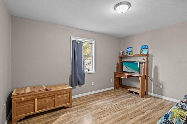 interior space featuring wood-type flooring and a textured ceiling