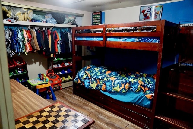 bedroom with wood-type flooring and a closet