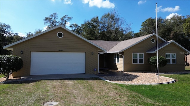 ranch-style house featuring a garage and a front yard