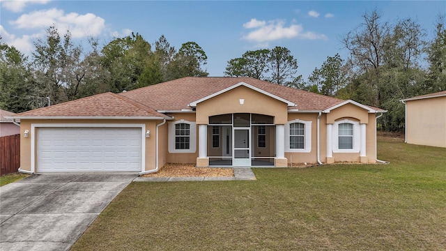 ranch-style house featuring a garage and a front lawn