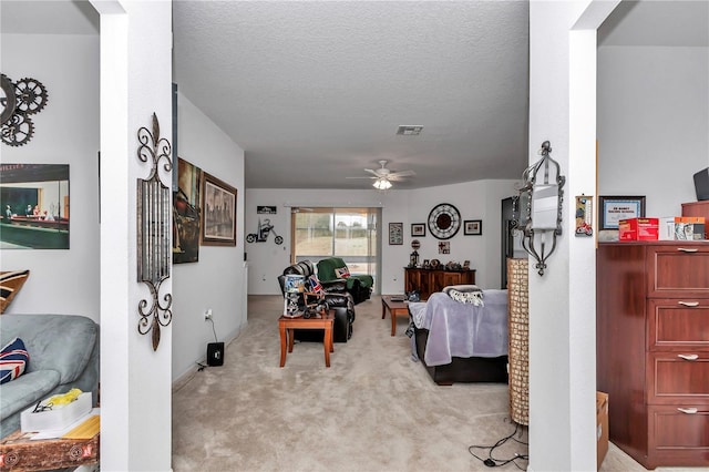 interior space with ceiling fan and a textured ceiling