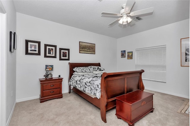 carpeted bedroom with a textured ceiling and ceiling fan