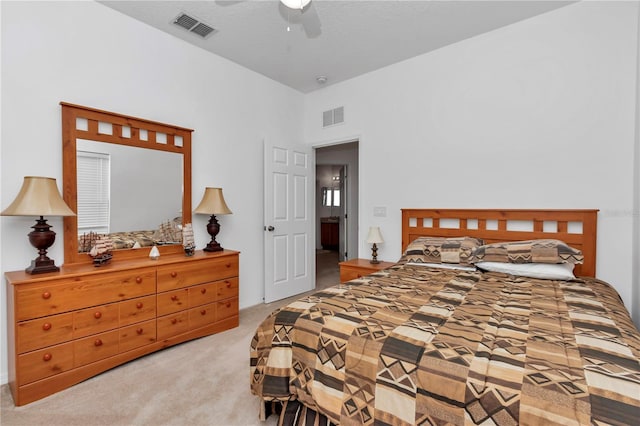 bedroom with ceiling fan and light colored carpet