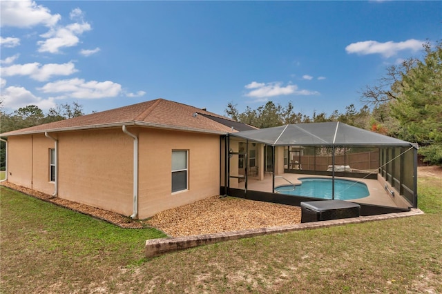 back of property with a yard, a lanai, and a patio