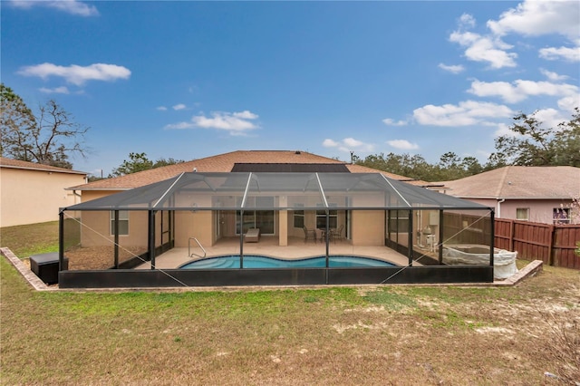 back of property with a fenced in pool, a lanai, a yard, and a patio area